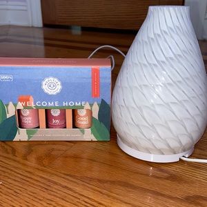 Essential oil diffuser and three essential oils.